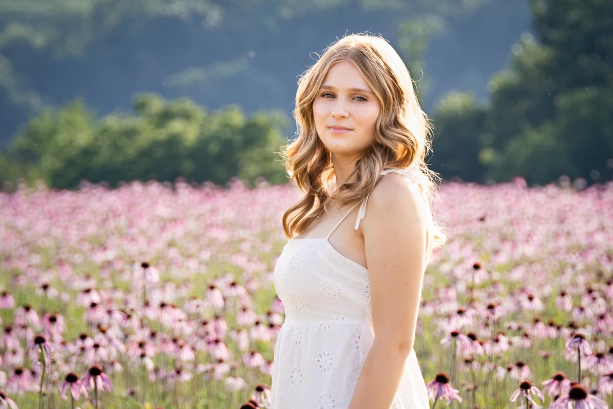 Young girl in a field of pink cone flowers