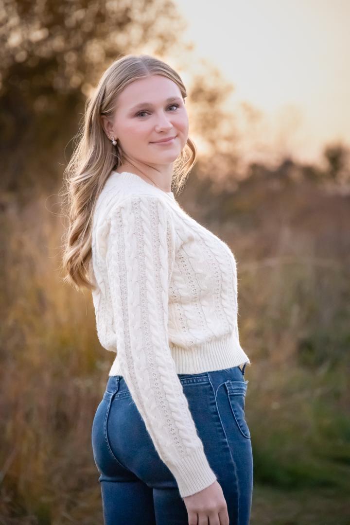 Girl looking over her shoulder in nature